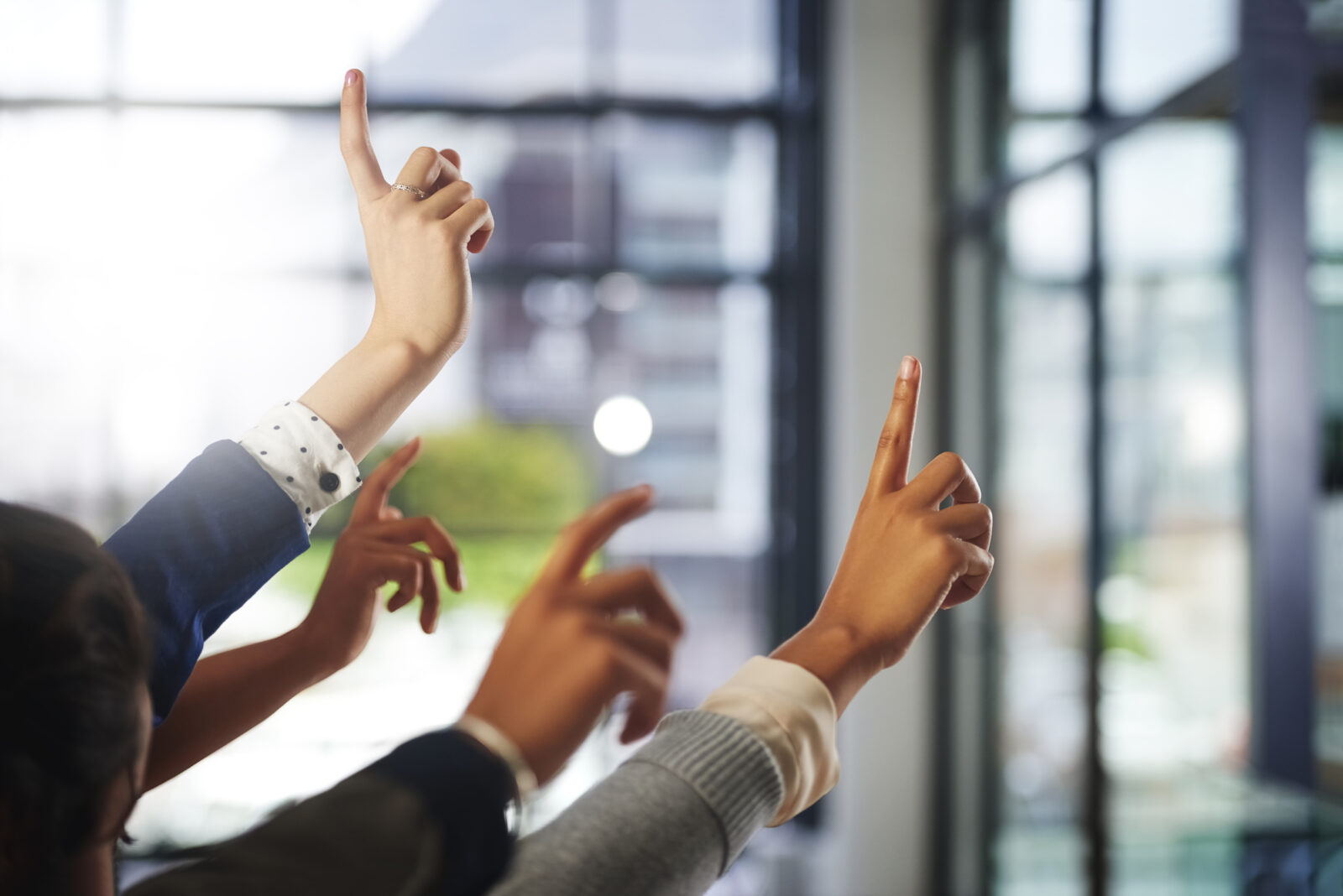 Hands up, workshop or business people in presentation asking questions for an answer or ideas. Teamwork, faq or employees with hand raised in group discussion meeting for problem solving or solution