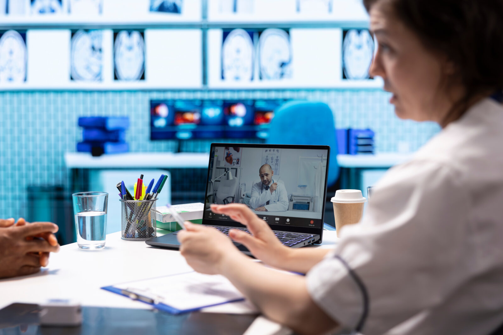 Medical team in a video call, discussing patient care in a modern office.